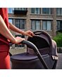 1518084110_F7_2026_maxicosi_stroller_oxfordcarrycot_espressobrown_lifestyle_momcheckingcarrycot